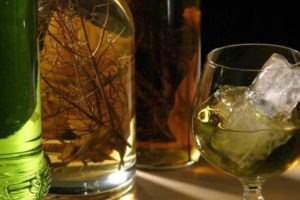 Hierbas bottle with herbs and glass